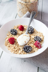 Oatmeal with berries. wooden on a white background. Breakfast