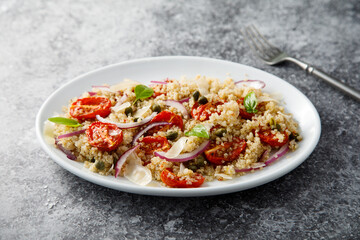 Warm couscous salad with tomatoes and red onion