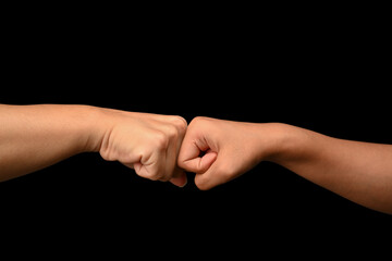 Friends giving fist bump to each other. Gesture of giving respect, showing unity, teamwork and friendship