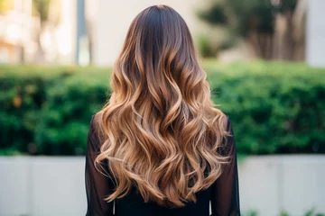 Tuinposter Woman from the back with balayage ombre hair dye technique, featuring a gradual transition from darker roots to lighter ends © KEA