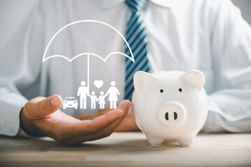 Businessman protects piggybank, holds family icon in hand, symbolizing saving, donation, family finance strategies. Depicting mes of charity, fundraising, superannuation, and financial crisis concept.