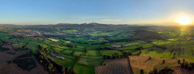 Panoramic view of a sunset over the Brecon Beacons looking towards the highest peaks of Penyfan and Corn Du in South Wales UK

