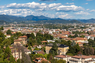 Fototapeta na wymiar Downtown Bergamo, Italy, August 7, 2023; Panoramic view of buildings, mountains and cloudy sky, Cityspase
