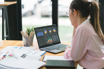 The data analyst woman working on a business analytics dashboard, utilizing charts and metrics to analyze performance and generate insightful reports for operations management.