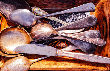 old stainless steel cutlery in a wooden box