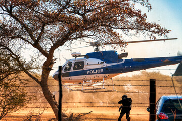 police helicopter landing on the ground, special forces SWAT with a search warrant fighting a war...