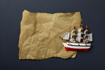 Columbus Day. Toy ship with an old sheet of paper