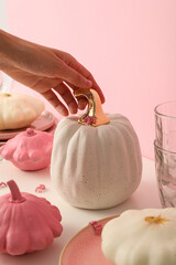 Table setting for Halloween in white and pink tones