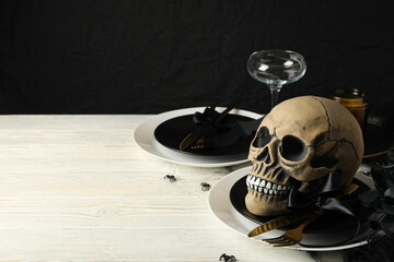 Table setting for Halloween, a skull in a bowl with spiders