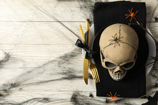 Table setting for Halloween, a skull in a bowl