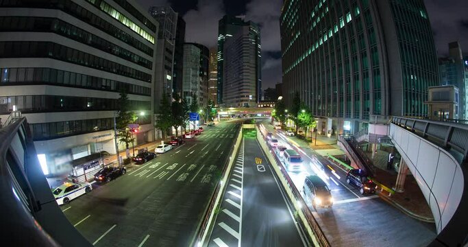 Downtown Tokyo Traffic Passes under pedestrian bridge night timelapse Japan
