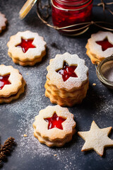 Obraz na płótnie Canvas Traditional Austrian home baked Christmas cookies Linzer eyes with raspberry jam powdered. Cozy atmosphere