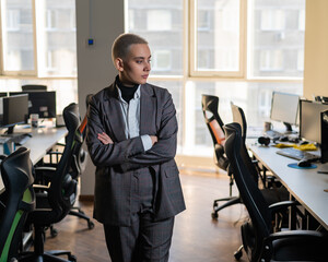 Business woman with short haircut in empty office. 