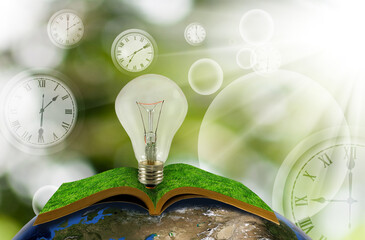 light bulb over an open book on the globe against the background of clock faces