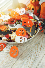 decorated holiday white table Halloween Jack o Lantern candy bowl with candy and halloween cookies Trick or Treat  background