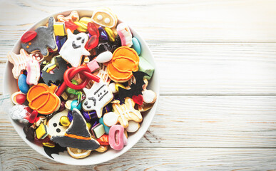 decorated holiday white table Halloween Jack o Lantern candy bowl with candy and halloween cookies Trick or Treat  background