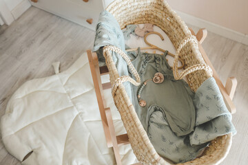 Fototapeta na wymiar Stylish outfit for a newborn in the cradle, concept in anticipation