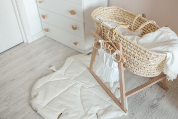 Fototapeta na wymiar Dress for a newborn girl on a wooden hanger in the nursery