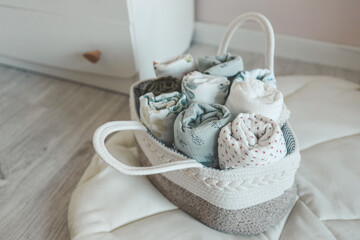 Fototapeta na wymiar Basket with baby muslin diapers for a newborn