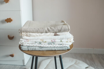Stack of baby muslin blankets and newborn diapers - obrazy, fototapety, plakaty