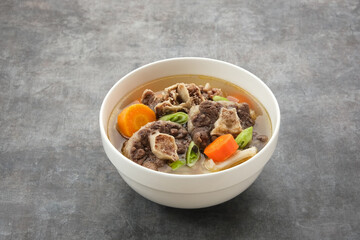 Sop Buntut or Oxtail Soup with carrot and potatoes. Indonesian traditional food
