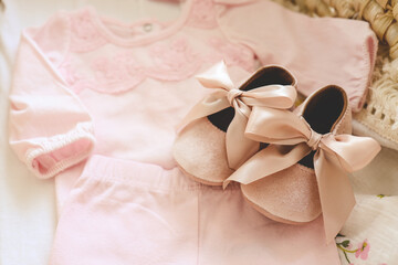 Lovely pink slippers and bodysuit for a newborn girl