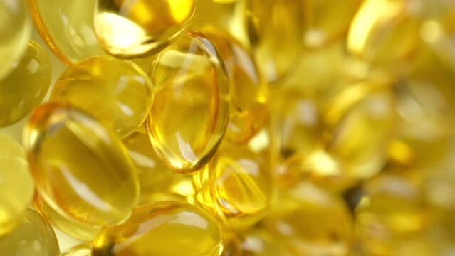 Yellow softgel capsule Vitamins Omega 3 or fish oil rotate. Pharmaceutical industry. Vertical video