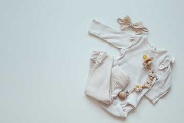 A set of baby clothes for a newborn in pastel colors, top view