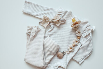 A set of baby clothes for a newborn in pastel colors, top view