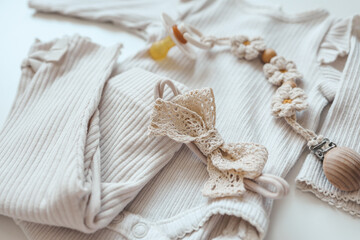 A set of baby clothes for a newborn in pastel colors, top view