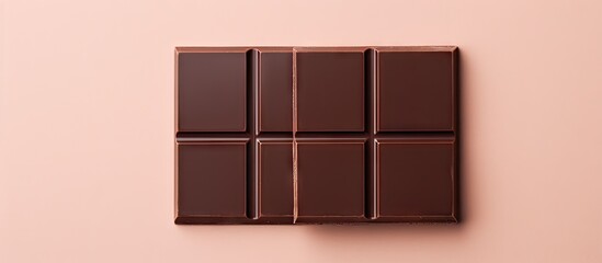 Closeup of two dark chocolate bars on a isolated pastel background Copy space
