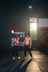 White man and Asian Woman Exercise Together. Synchronized Fitness. Couple Squats in Perfect Harmony...