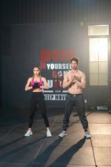 White man and Asian Woman Exercise Together. Synchronized Fitness. Couple Squats in Perfect Harmony...