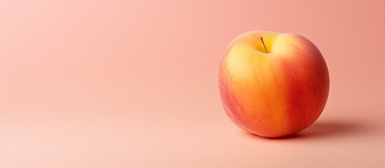 Gorgeous ripe peach stands alone on isolated pastel background Copy space