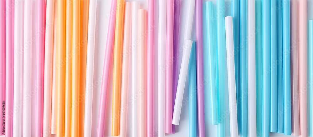 Poster assorted plastic straws in various colors isolated pastel background copy space