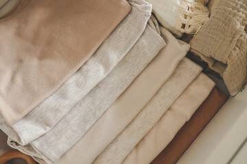 Stack of children's neutral clothes, fabric close-up © shine.graphics