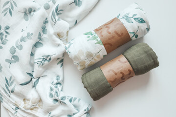 Two baby muslin blankets on white background, top view
