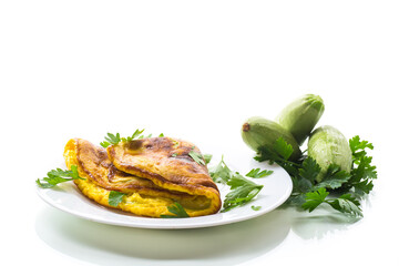 Fried omelette with zucchini,in a plate on a white background.
