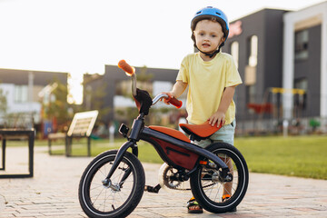 Cute little boy learning to ride a bicycle