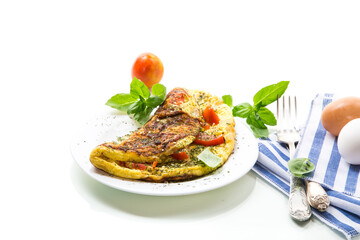 Stuffed omelette with tomatoes isolated on white background.