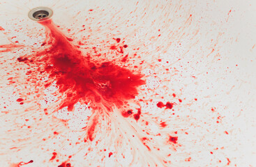 Fresh red blood splat on white porcelain with specks from the impact. Copy space area for horror...