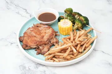 chicken chop with fries, corn and greens