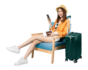 Happy Asian woman traveler sitting on the chair and using smartphone with holding passport and plane tickets with suitcase isolated.