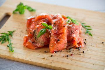 Fresh big pieces of salted red fish with spices and herbs .
