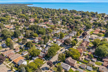 Fototapeta na wymiar Racine, WI USA - August 31, 2023: Aerial view of Racine Wisconsin featuring city streets and Lake Michigan 