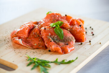 Fresh big pieces of salted red fish with spices and herbs .