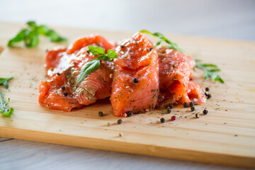 Fresh big pieces of salted red fish with spices and herbs .