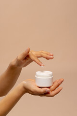 Vertical of hands of asian woman using jar of beauty cream with copy space