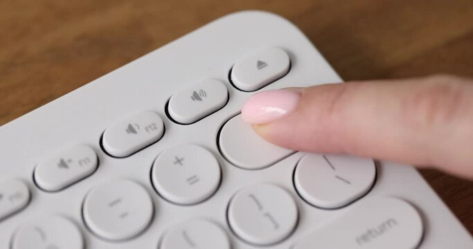 Finger presses delete key on computer keyboard. Removing information