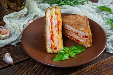 Sandwiches fried in breadcrumbs with ham, cheese and tomatoes